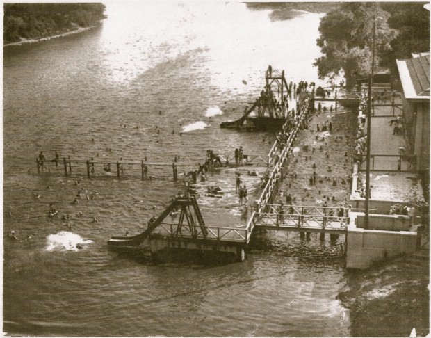 The Gordon Park swimming area in happier days. The concrete retaining wall supporting ramps leading to deeper water can be seen in this photo and the wall is all that remains, high and dry and covered with graffiti. Courtesy Milwaukee County Historical Society