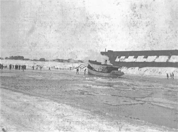 The crew of the Julius Goll works to free the little steamship from an ice shelf. An ice house is in the background. Courtesy Milwaukee County Historical Society