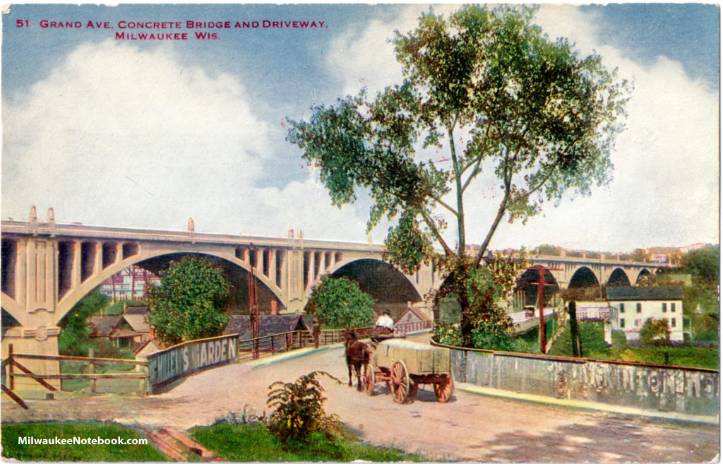 A horse cart is featured in this vintage postcard view of Milwaukee's original Grand Avenue viaduct