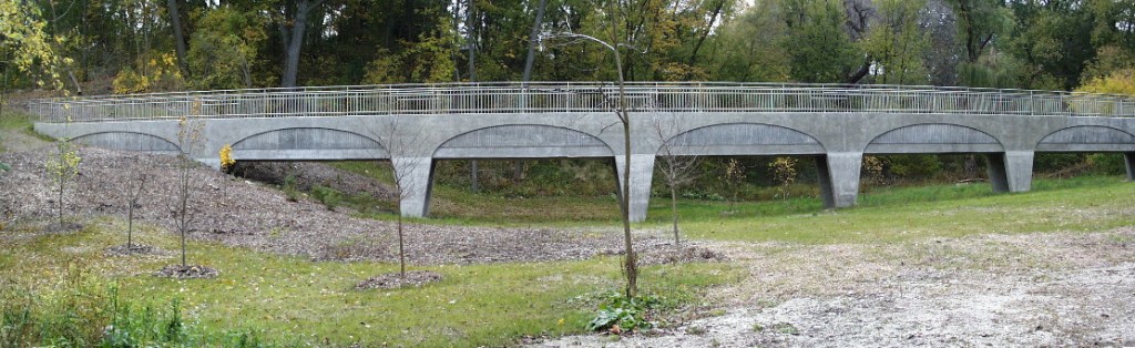 A panoramic view of the aqueduct from October 2000 shows tidy landscaping and small trees.